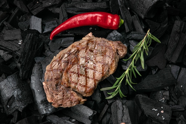 Bistec a la parrilla sobre un fondo de carbón negro