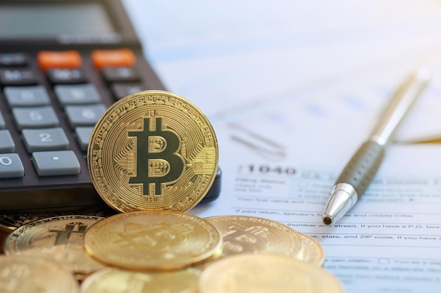 Bitcoin en una calculadora y formulario de declaración de impuestos sobre la renta individual 1040. impuesto para el comercio de criptomonedas. El concepto de tiempo para pagar impuestos.