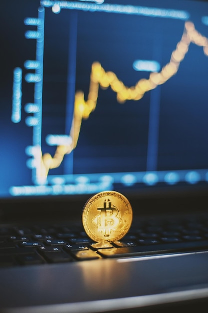 Bitcoin no teclado do computador e gráfico de crescimento