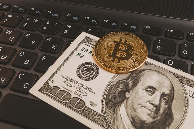 Bitcoin en un teclado de computadora y $ 100