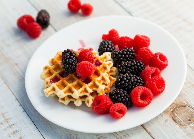 Blackberry e framboesa com um waffle em um prato branco