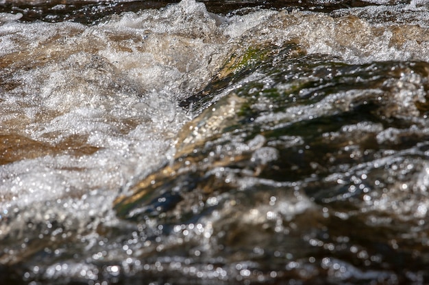 Blasen mit Schaum an der Schwelle des Flusses