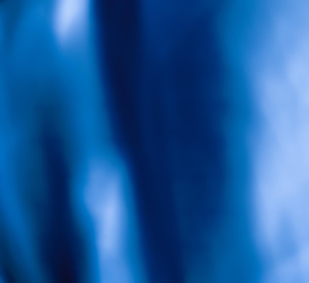 Foto blaue abstrakte kunsthintergrund-seidenstruktur und wellenlinien in bewegung für klassisches luxusdesign