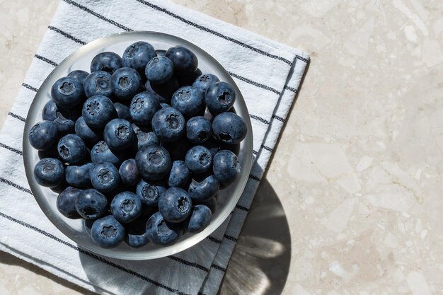 Blaue Blaubeeren in einer Schüssel auf einer Tuchdraufsicht