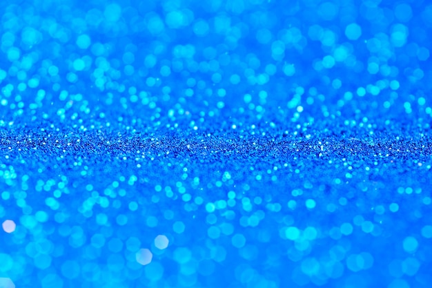 Blaue Glitzertextur. Neujahrs- oder Weihnachtshintergrund für Grußkarten. Valentinstag Feier. Glänzendes Glitzerdesign für festliche Dekoration: Hochzeits-, Urlaubs- oder Jubiläumsfeier.