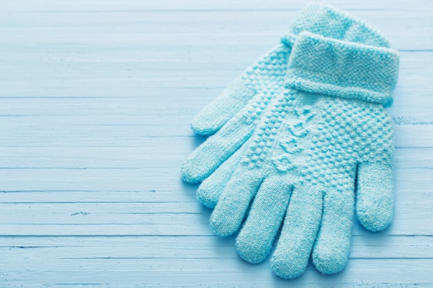 Blaue Handschuhe auf blauer Holzwand