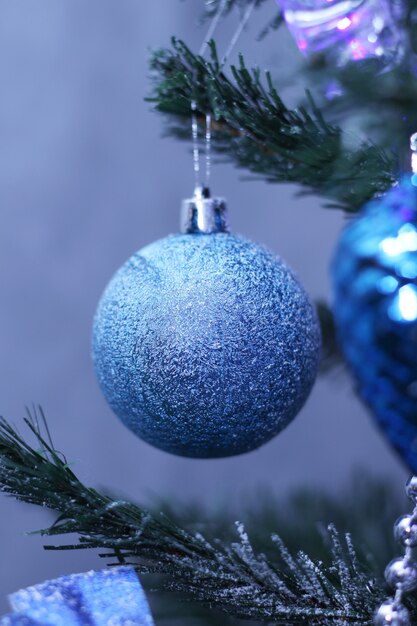 Blaue Kugel hängt am Weihnachtsbaum