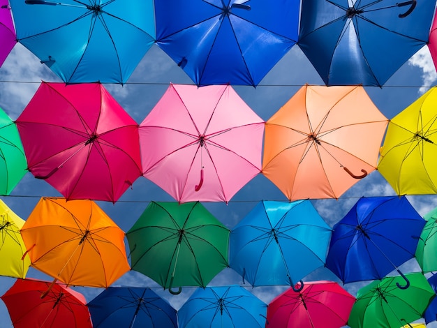 Blauer Himmel verziert mit den bunten Regenschirmen, die über der Straße hängen