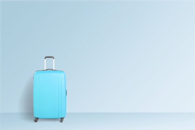 Blauer Koffer auf blauem Hintergrund