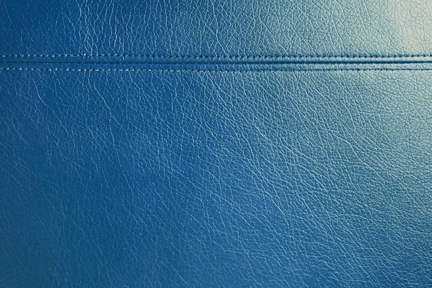 Blauer Lederkunstleder-Texturhintergrund mit dekorativem Stich