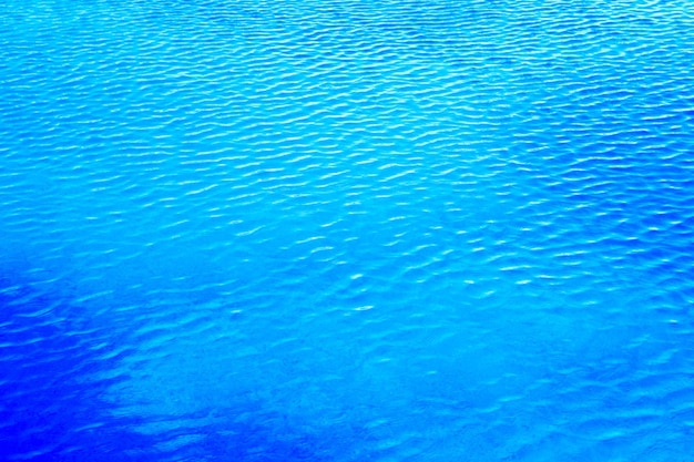 Blaues Poolwasser mit Sonnenreflexionen