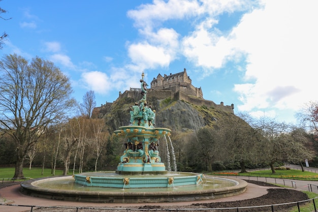 Blick auf das edinburgh castle und den ross-brunnen von den princes street-gärten in edinburgh, schottland