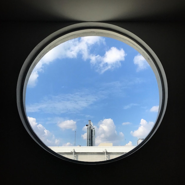 Foto blick auf den blauen himmel aus einem kreisfenster