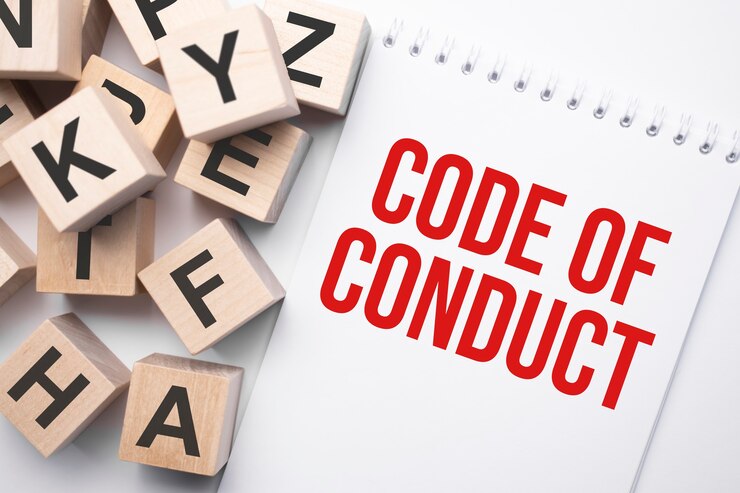 Foto bloc de notas con código de conducta de texto y cubos de madera con letras