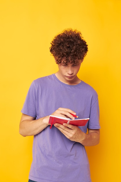 Bloco de notas ruivo bonito com caneta aprendendo emoções fundo amarelo inalterado