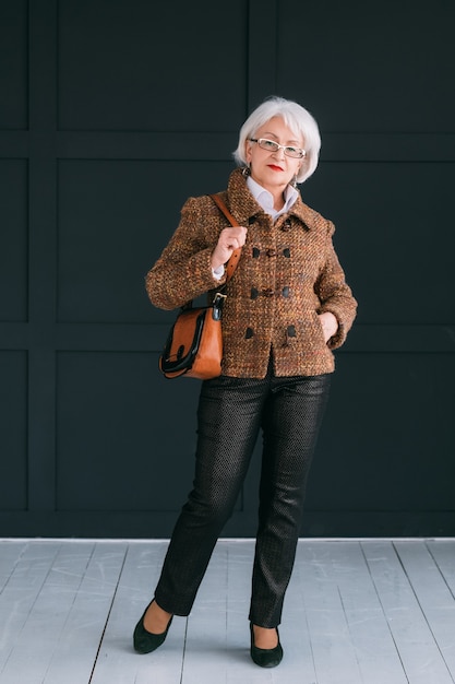 blogger estilista de moda senior. anciana en traje de otoño de moda disparando vlog.