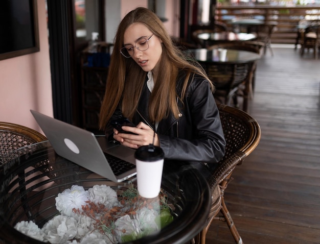 Blogger jovem trabalhando com laptop no café