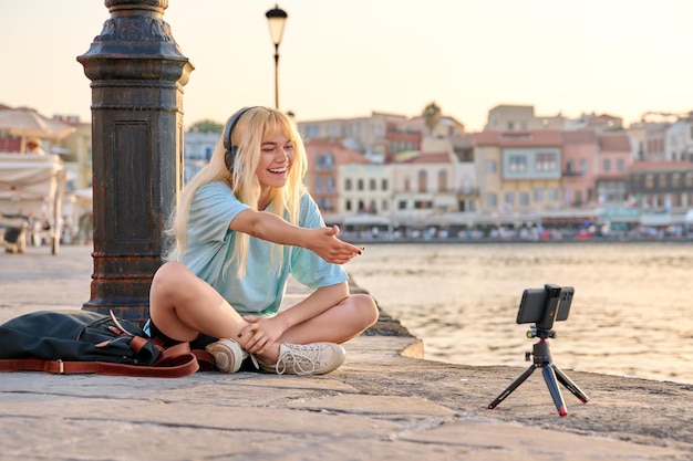 Blogueira adolescente gravando conteúdo de vídeo conversando com seguidores usando smartphone