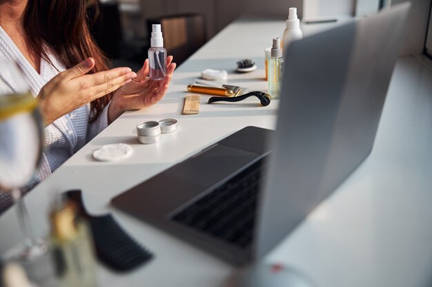 Foto bloguera competente que hace una revisión en línea de sus cosméticos.