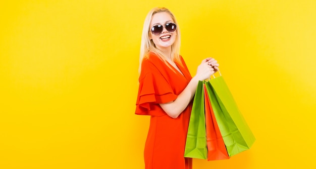 Blonde Frau im Kleid mit Taschen