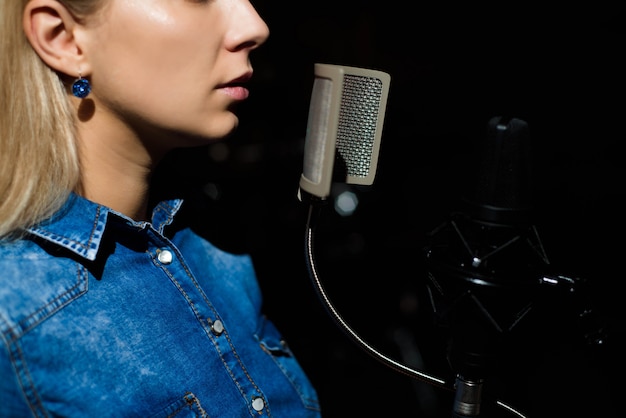 Blonde singende Frau in einem Tonstudio