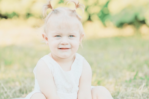 Blondes Baby im Park im Sommer. Foto in hoher Qualität