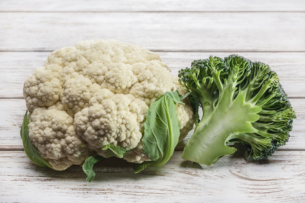 Blumenkohl und Brokkoli auf altem Holztisch