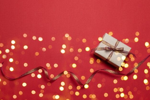 Boas festas cartão com estrela ouro glitter sparkle confete e caixa de presente em fundo vermelho