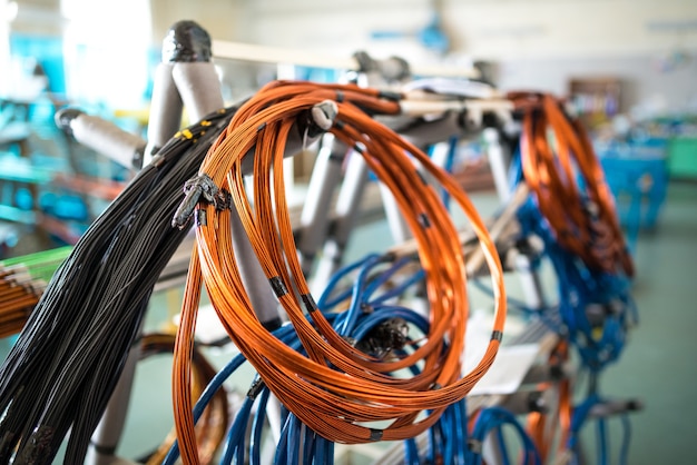 Bobina de alambre de cobre cuelga de una rejilla de hierro en la fabricación de electrodomésticos y artículos eléctricos. Concepto de gran producción industrial