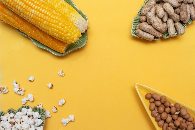 Bocadillos brasileños de junio como palomitas de maíz y maíz en un fondo amarillo