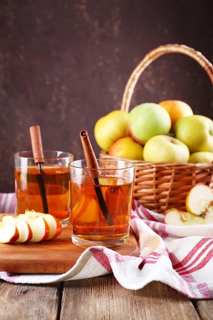 Bodegón con sidra de manzana y manzanas frescas en mesa de madera