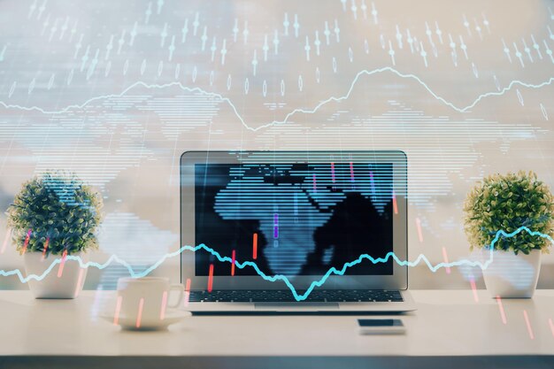 Börsendiagramm auf Hintergrund mit Schreibtisch und PC Doppelbelichtung Konzept der Finanzanalyse