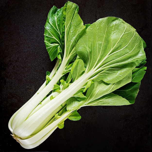 Bok choy o chino-col en la mesa negro. Pak Choi. Vista superior