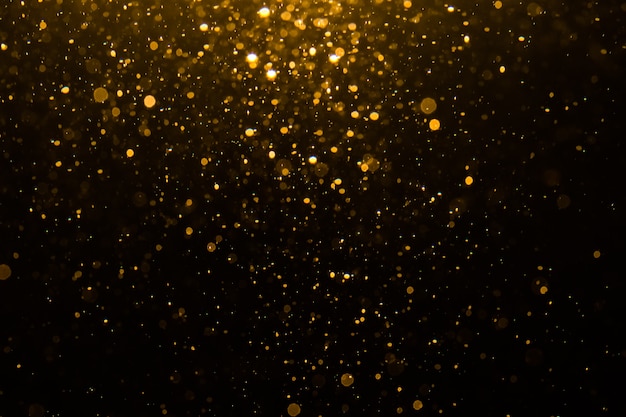 Bokeh abstracto de oro con fondo negro