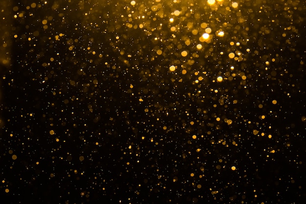 Foto bokeh abstracto de oro con fondo negro