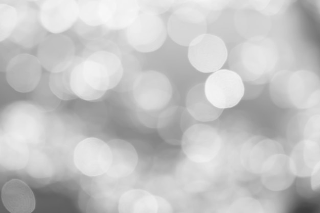 Bokeh cinza com fundo abstrato de cor branca pode ser usado como papel de parede fundo de cartão de natal ou fundo de cartão de ano novo o fundo mostra bokeh de luz que na luz desfocada