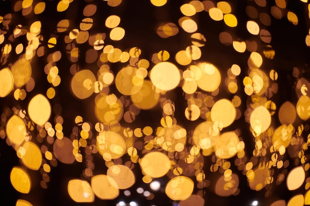 Bokeh de luzes amarelas de guirlandas de férias de natal turva luzes abstratas de fundo festivo