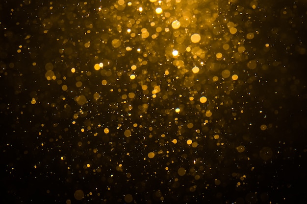 Bokeh dorado abstracto con fondo negro