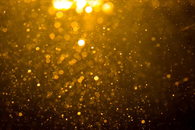Bokeh dorado abstracto con fondo negro