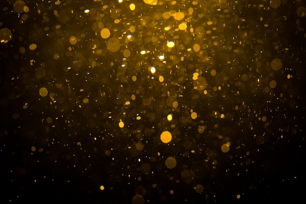 Bokeh dorado abstracto con fondo negro