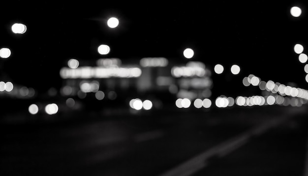 Bokeh de fondo abstracto de la calle de noche con coche y farolas