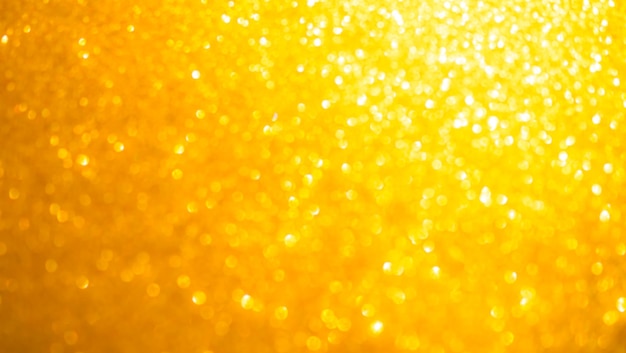 Bokeh Oro Brillo Luz Abstracto Fondo oscuro Polvo Navidad Brillo Amarillo