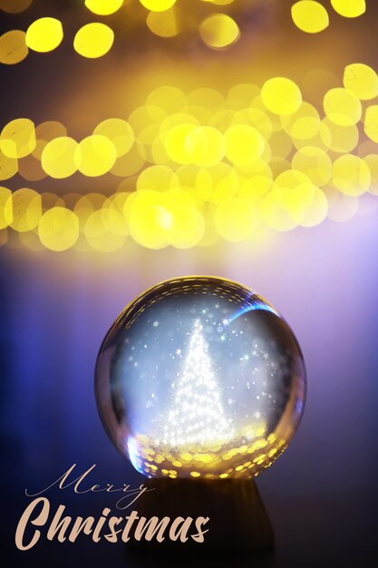 Foto bola de cristal en el suelo con bokeh, luces detrás. bola de cristal con luz colorida bokeh, concepto de celebración de año nuevo.