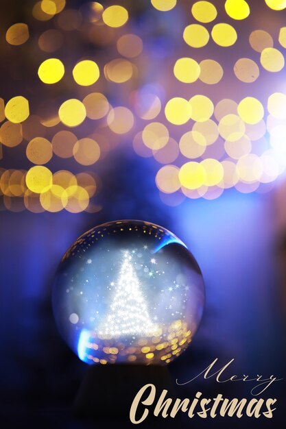 Foto bola de cristal en el suelo con bokeh, luces detrás. bola de cristal con luz colorida bokeh, concepto de celebración de año nuevo.