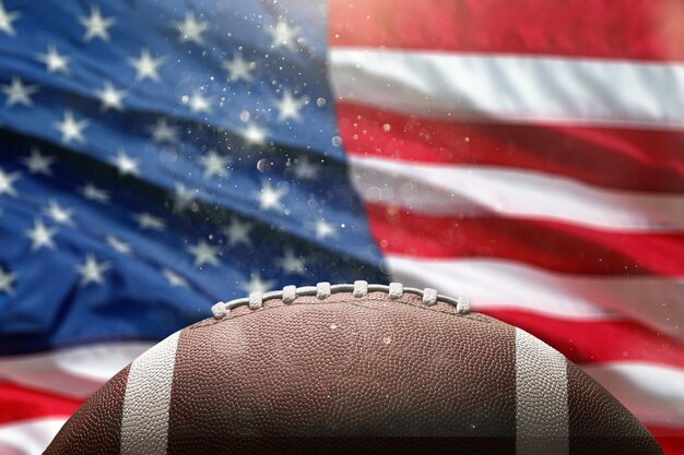 Foto bola de futebol americano de couro no fundo da bandeira