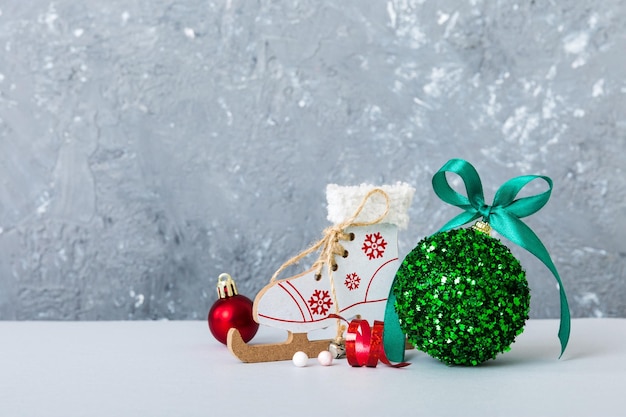 Bola de natal com patins em enfeite de decoração de fundo colorido com laço de fita com espaço de cópia