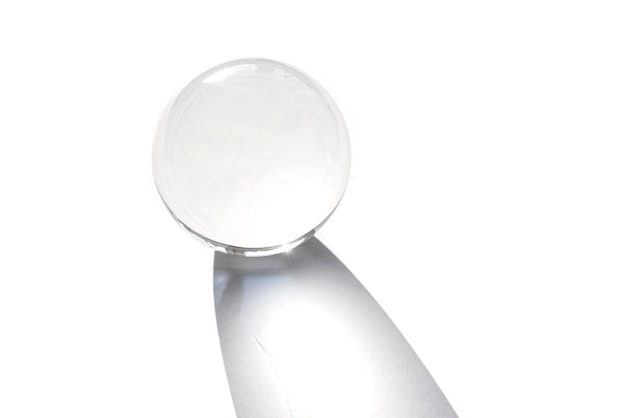 Bola de globo de cristal aislada sobre fondo blanco. Bola de globo como decoración de interior con sombra por la luz del sol