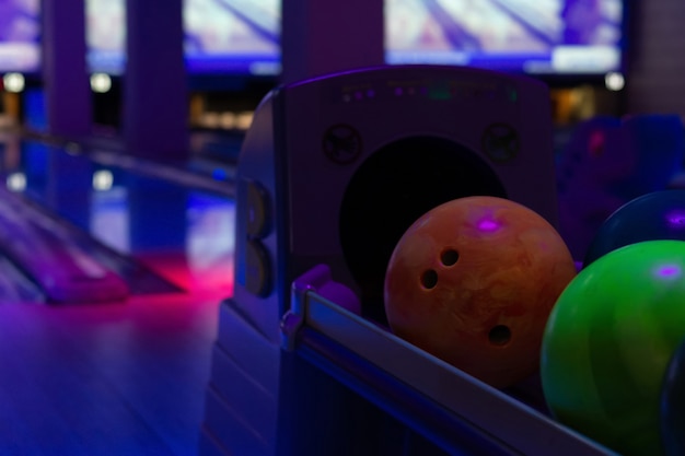 Foto bolas de bolos de colores sobre un soporte en un club de bolos