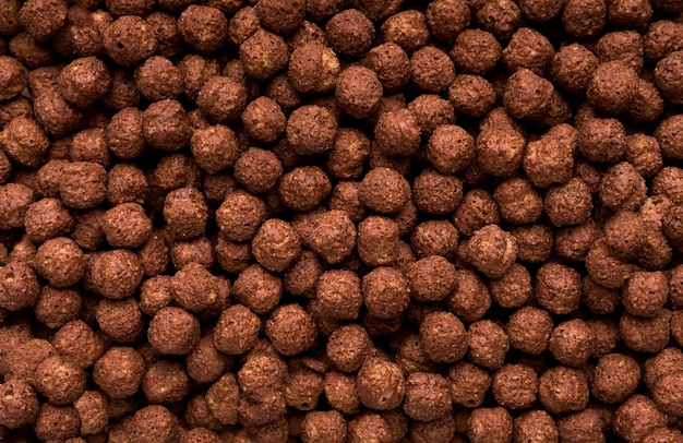 Bolas de cereales para el desayuno de chocolate o textura de fondo, primer plano