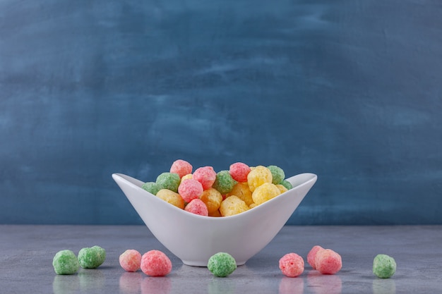 Bolas de cereais coloridas colocadas em um quadro branco.